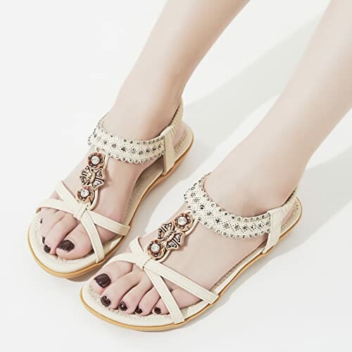 Beige decorative sandals on feet