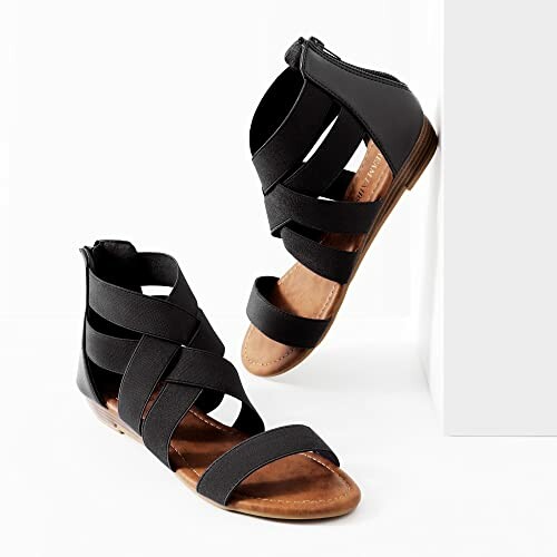 Black strappy sandals with flat sole and back zipper