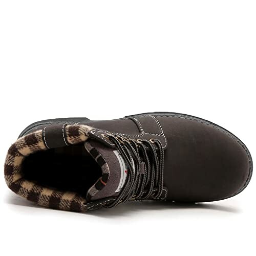 Top view of a brown boot with plaid interior lining.