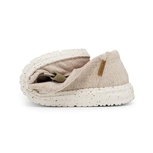 Folded casual shoe with speckled sole and beige fabric upper.