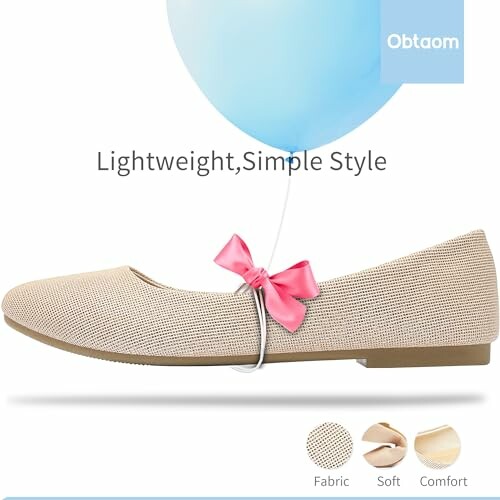 Lightweight beige shoe with a pink bow and blue balloon