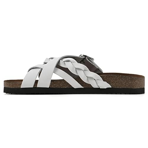 Side view of white leather sandals with braided straps.