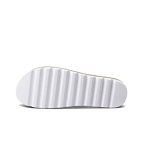 Bottom view of a white shoe sole with ridged design.