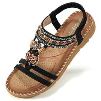 Women's beaded sandal with decorative straps and cushioned sole.